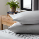 Ash colored pillows on ash colored sheets