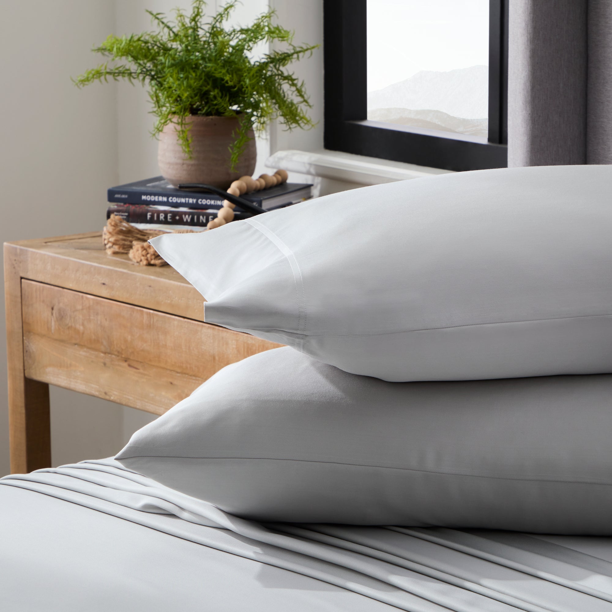 Ash colored pillows on ash colored sheets